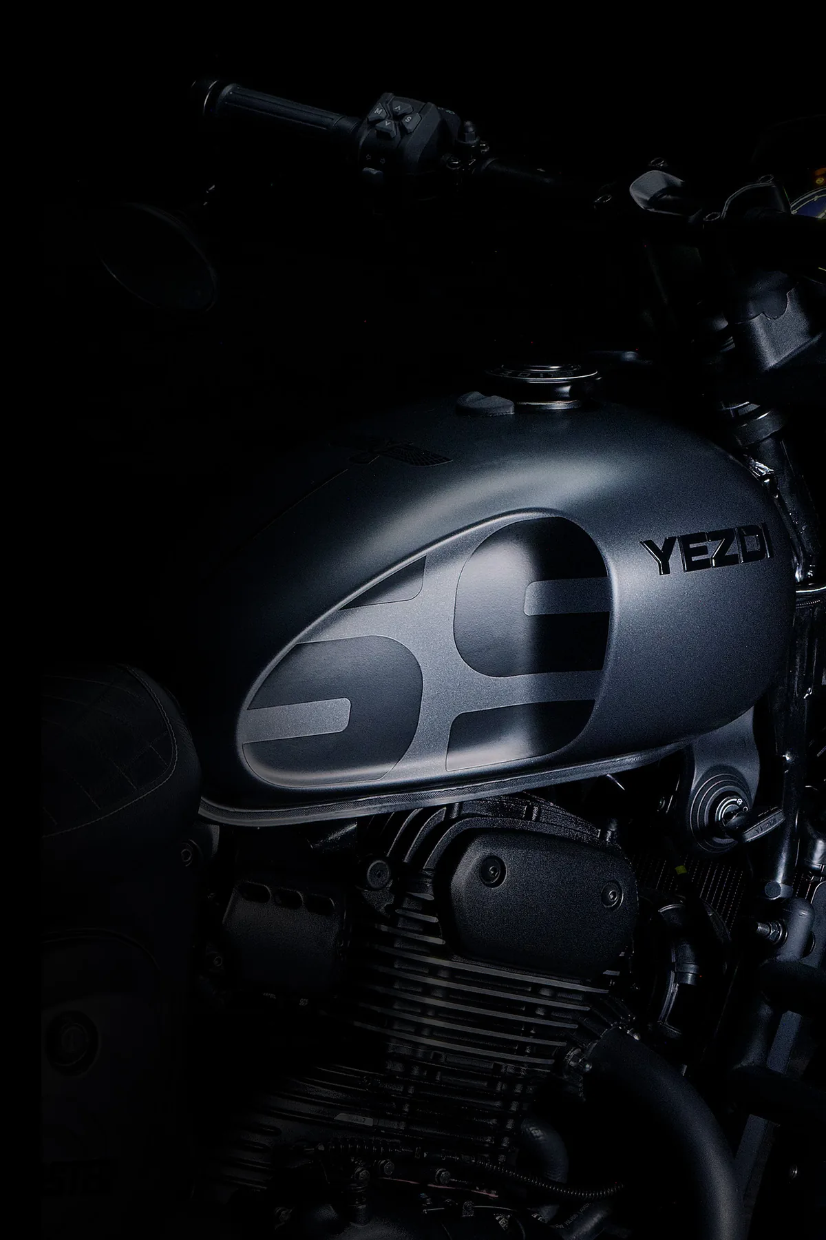 Close view of the matte grey Roadster tank with its 69 graphic and the engine below.